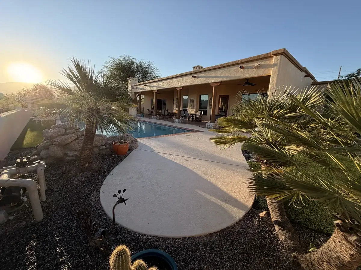 Southern Arizona property with pool, gravel beds, and desert landscaping