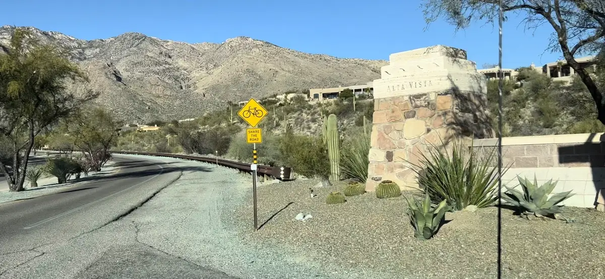 Community roadway with mountain backdrop and desert landscape