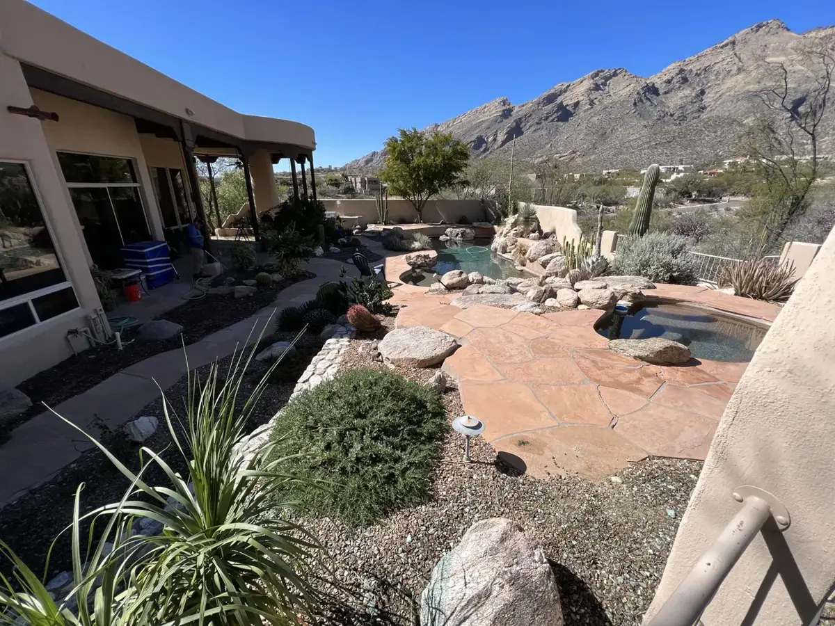 Desert residential landscape with rock beds and patio